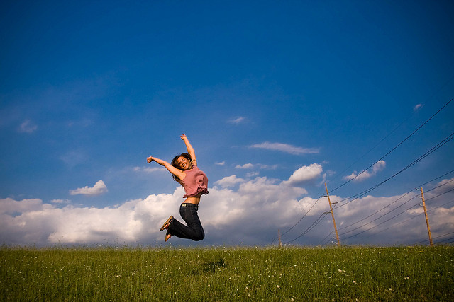 happy girl jumping in field