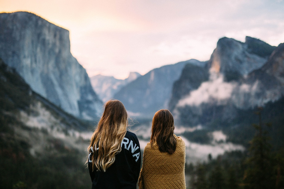 two women looking at the mountains